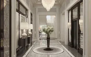 Geniş holde yuvarlak masa çevresinde çift bordürlü mermer zemin